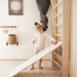 Kids practicing climbing and exercise on wall bars